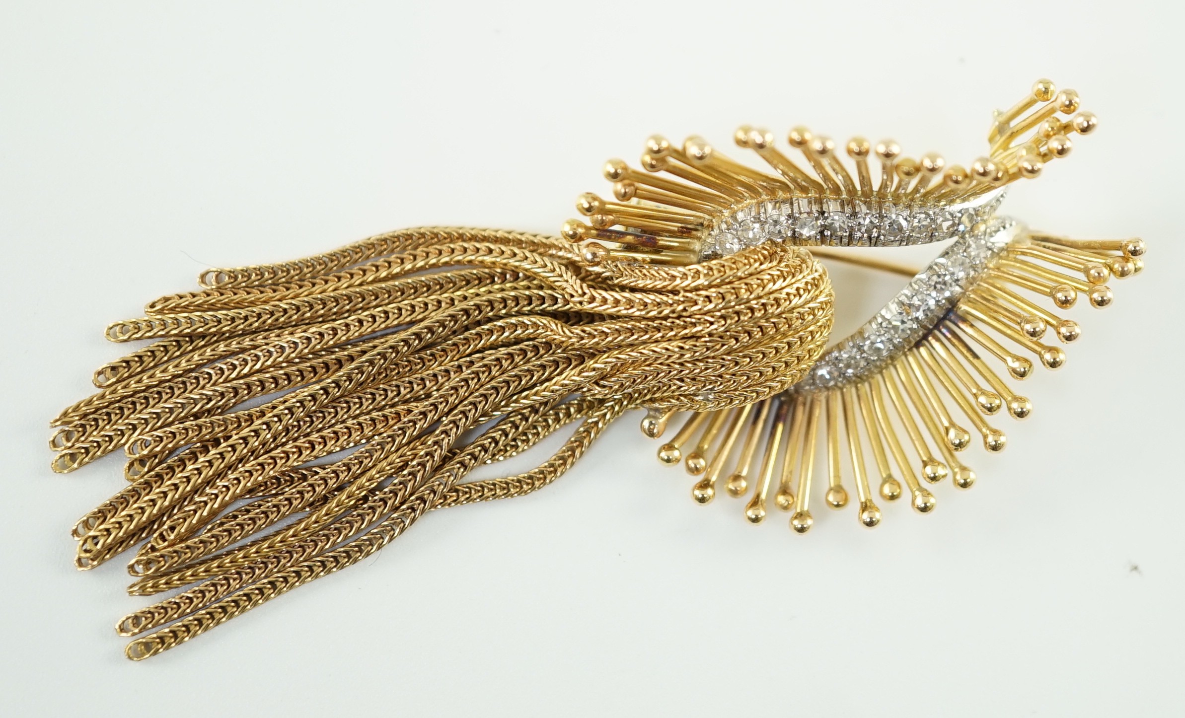 A late 20th century stylish continental gold and diamond cluster set tassel brooch